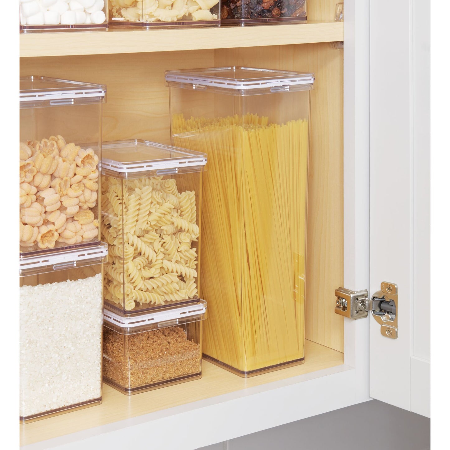 Clear storage containers with food items inside a cabinet