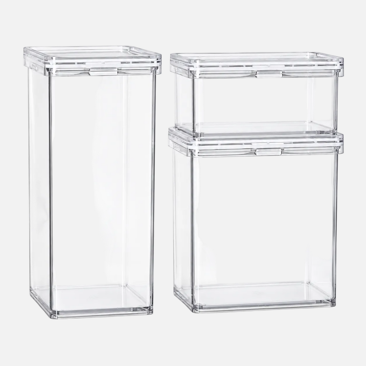 Three clear plastic storage containers with matching lids, including one tall narrow container and two shorter wider containers stacked together, shown on a white background.