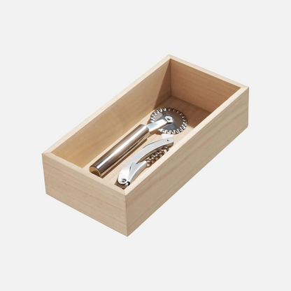 A light natural wood presentation box containing two stainless steel bar tools, likely cocktail or pastry accessories, photographed on a clean white background.