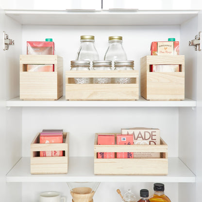 Wooden storage boxes on shelves with jars and containers