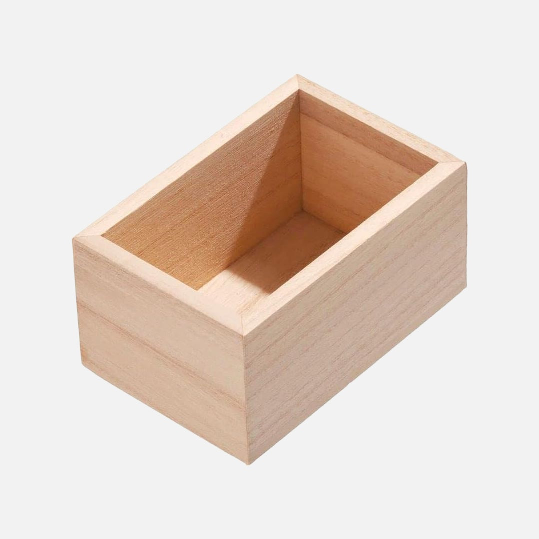 A small rectangular open wooden box made of light natural wood, shown at an angle on a plain light gray background.