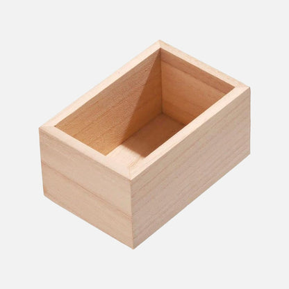 A small rectangular open wooden box made of light natural wood, shown at an angle on a plain light gray background.