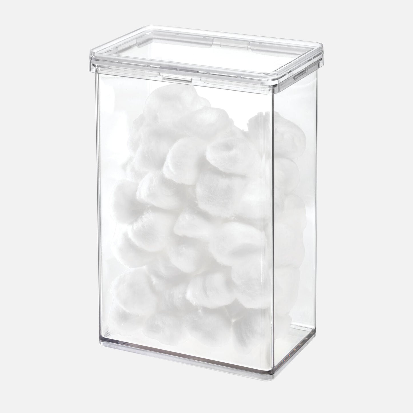Clear rectangular container filled with white cotton balls on a white background