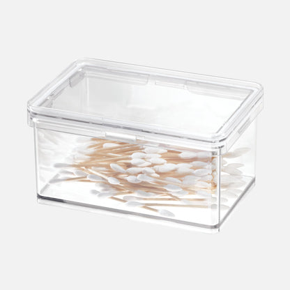 Clear plastic container filled with cotton swabs on a white background