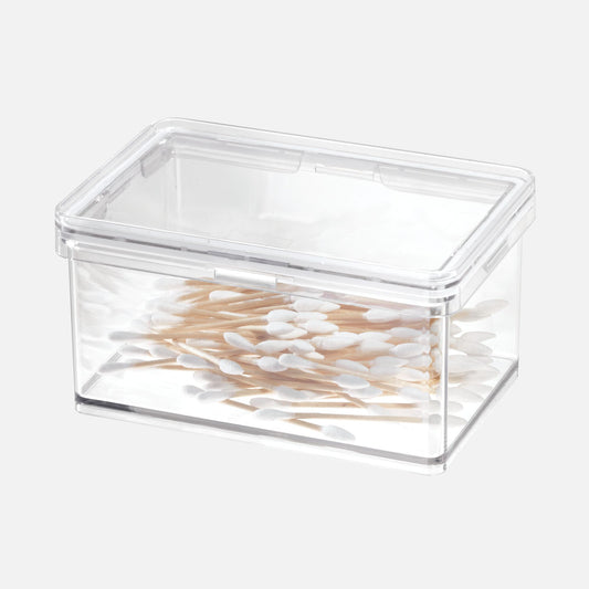 Clear plastic container filled with cotton swabs on a white background