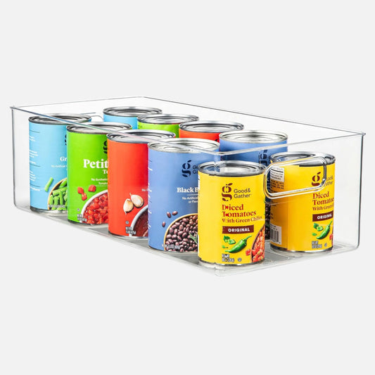 Clear can organizer with canned goods on a white background